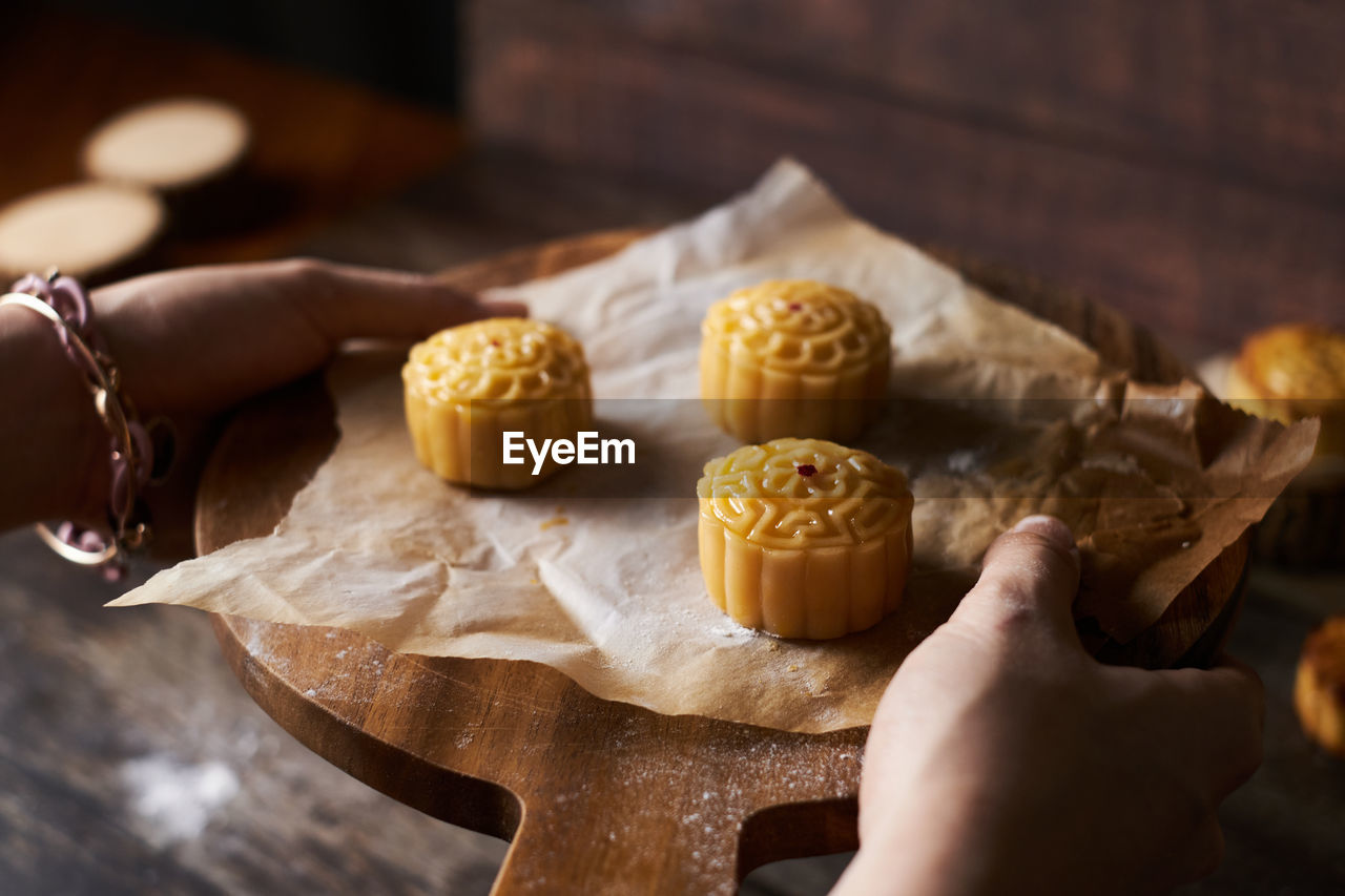 HIGH ANGLE VIEW OF HAND PREPARING FOOD