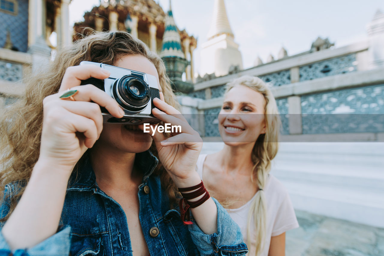 Happy women at temple in city