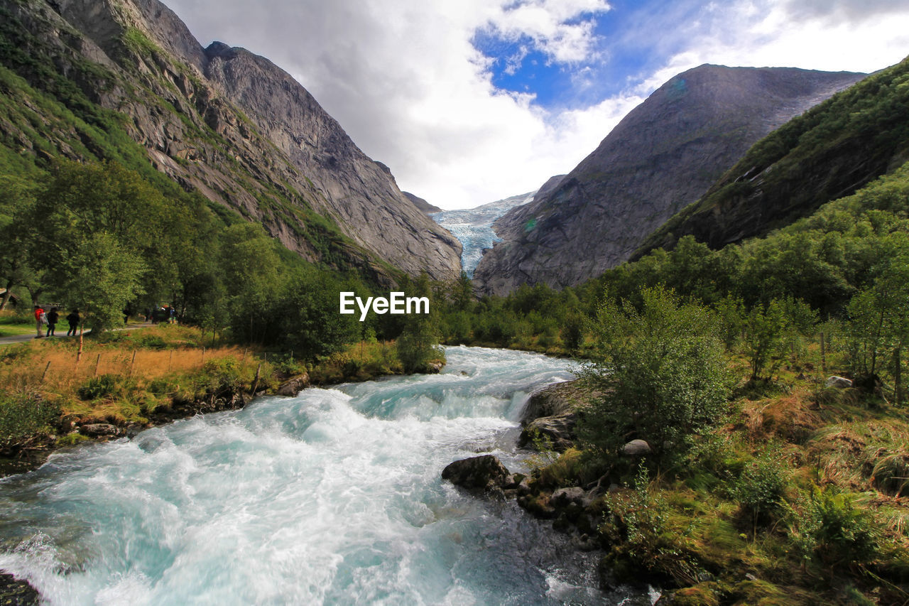 SCENIC VIEW OF RIVER FLOWING THROUGH MOUNTAINS AGAINST SKY