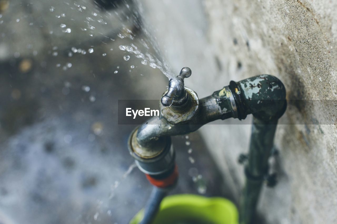 High angle view of water leaking from faucet