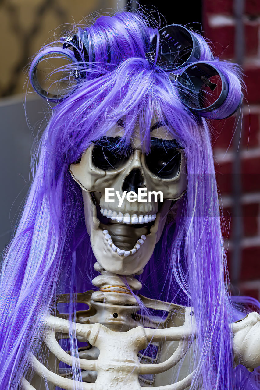 Halloween skeleton with wig and curlers