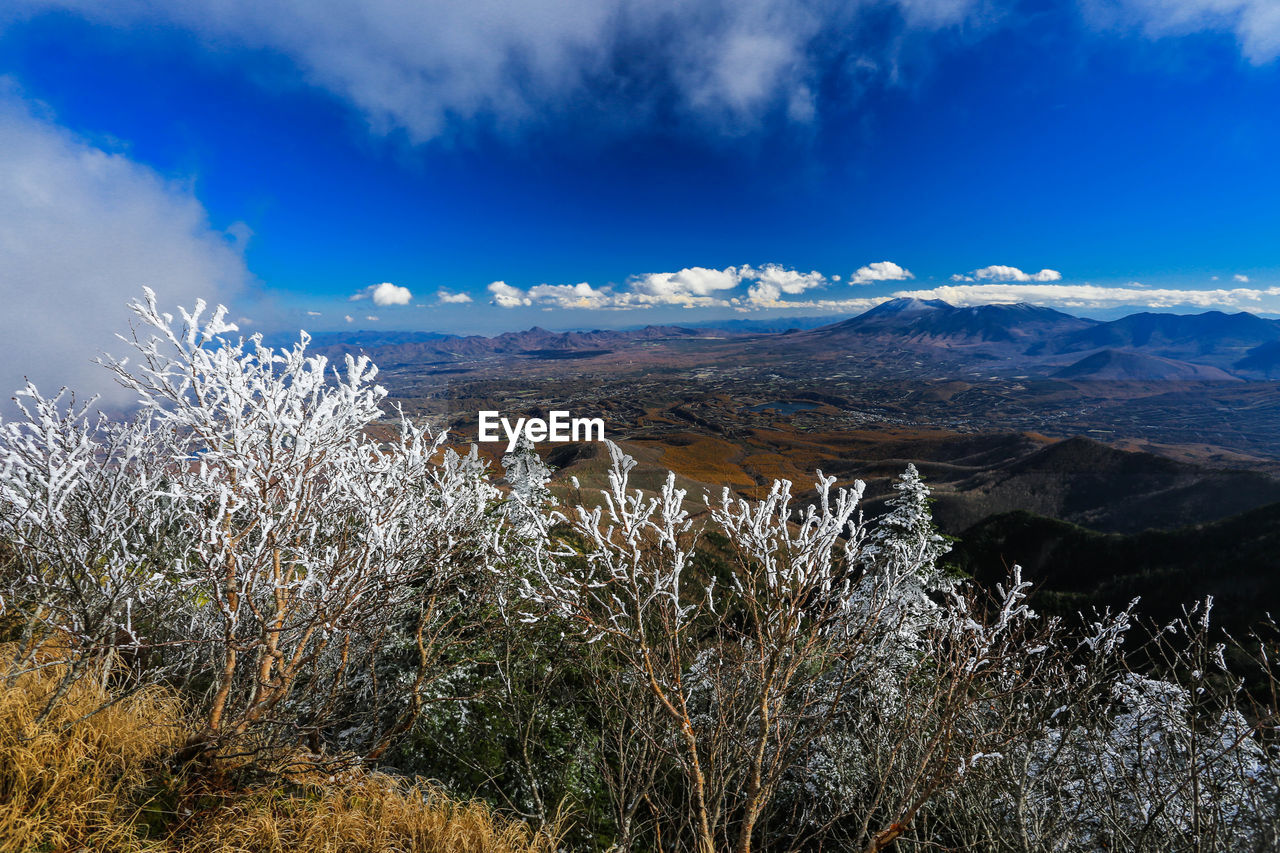 Scenic view of mountains against blue sky