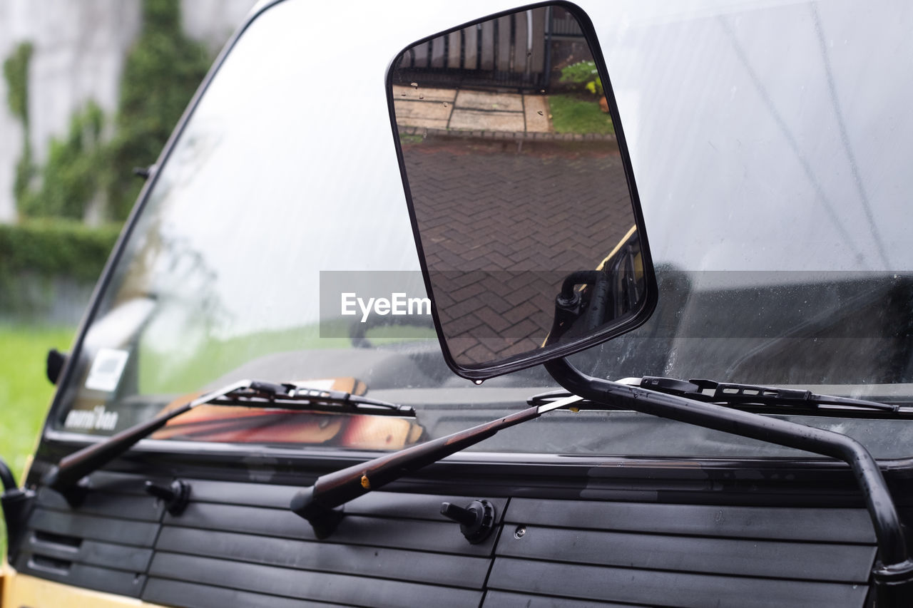 Close-up of side-view mirror of car