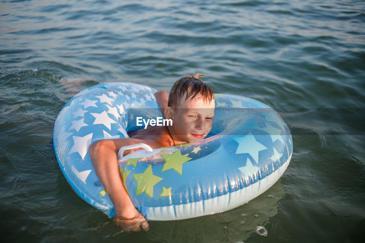 high angle view of young man swimming in sea