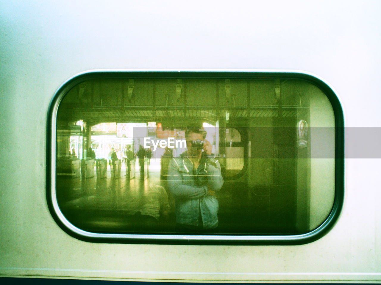 Man reflection on train window