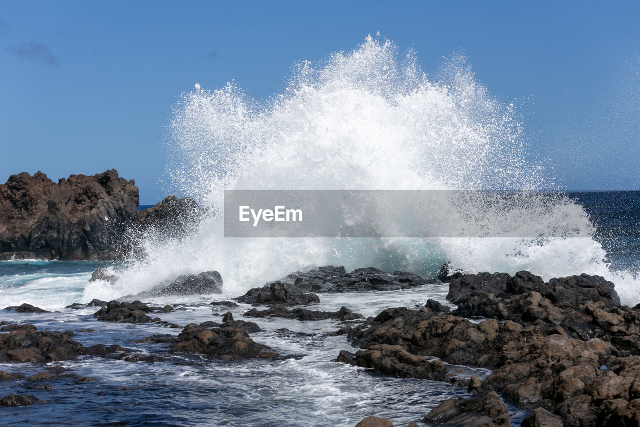 Sea waves splashing on rocks