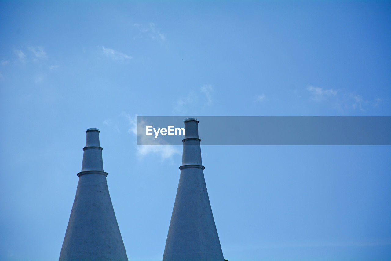 Low angle view of smoke stack against sky