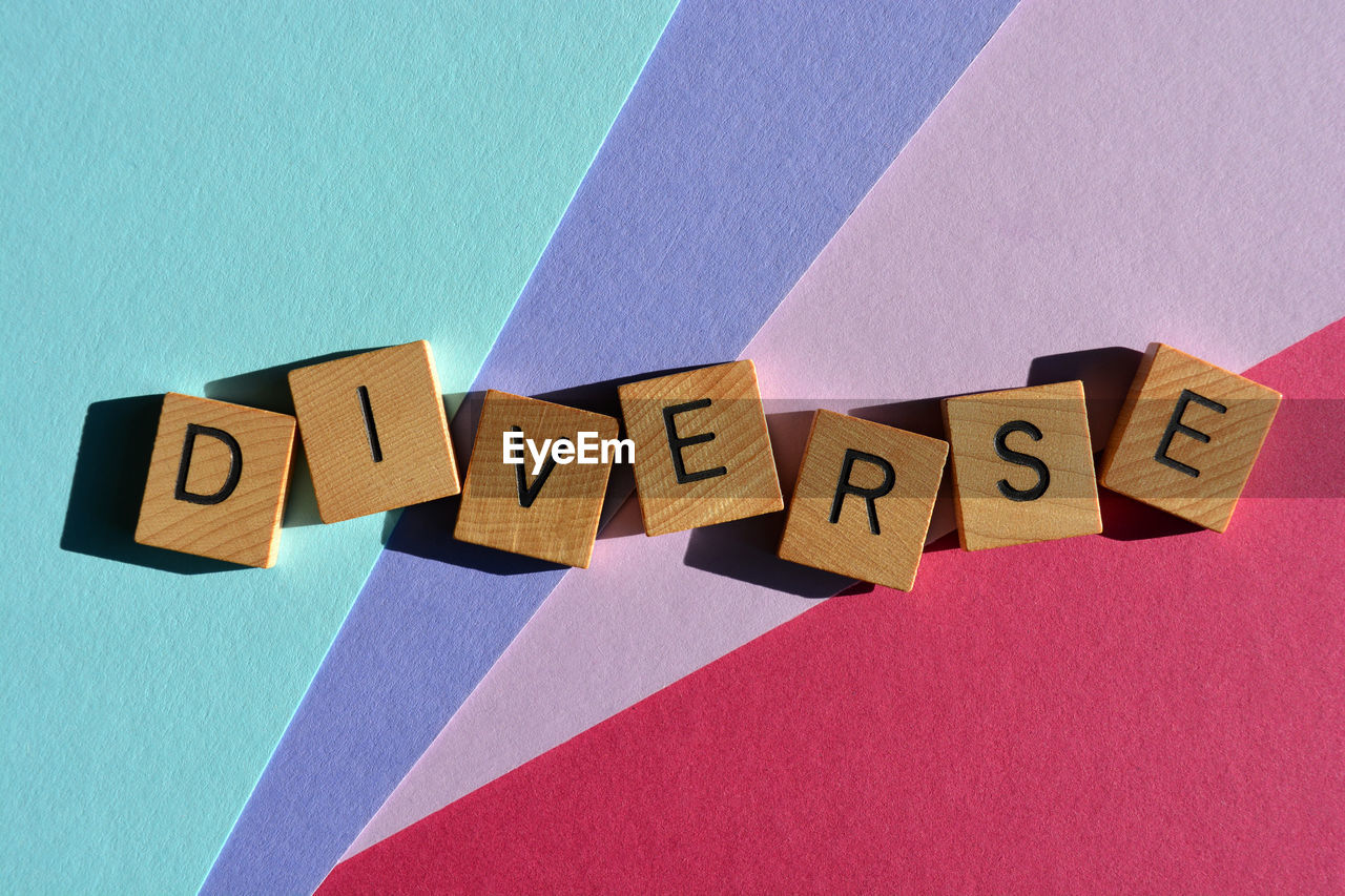 Diverse, word in wooden alphabet letters isolated on colourful background