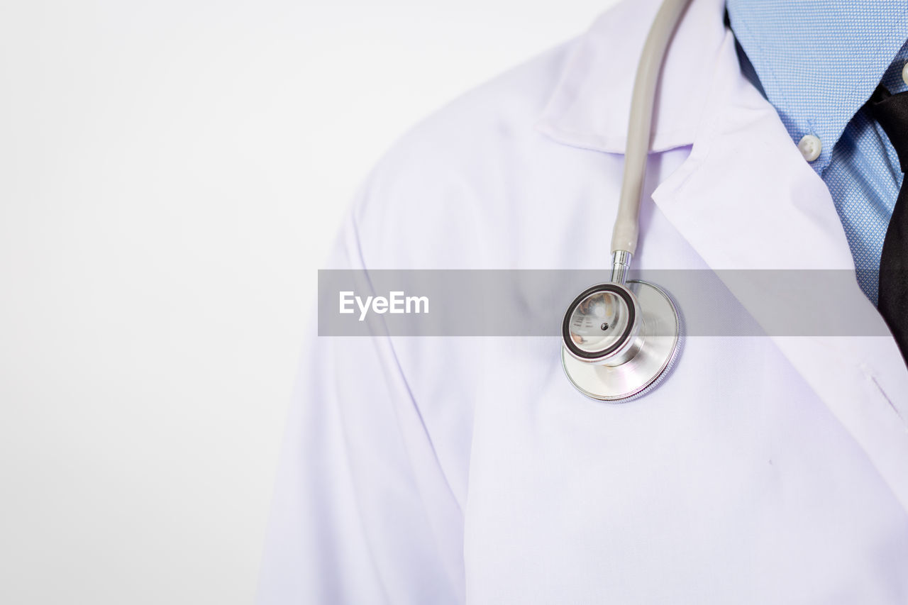 Close-up of doctor against white background