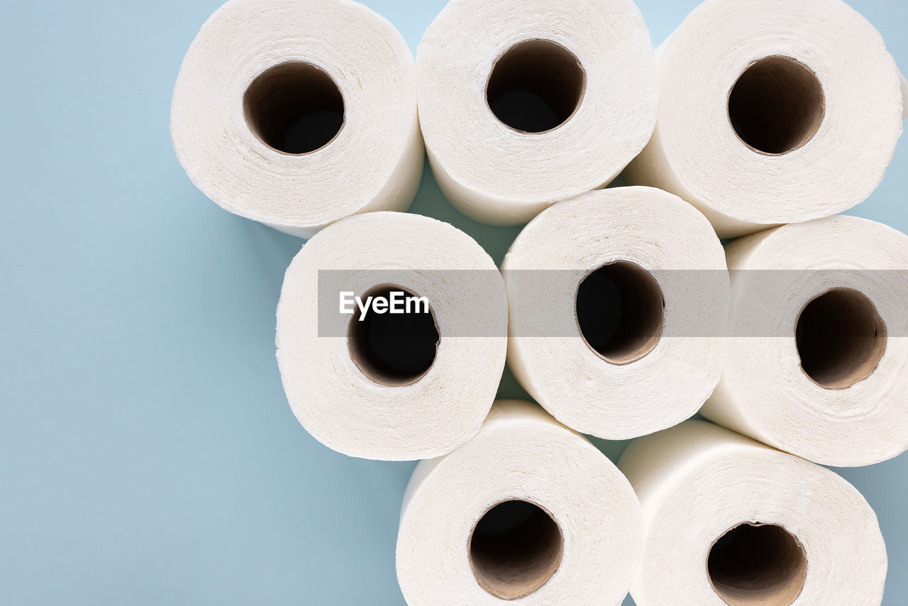 New white toilet paper rolls on blue background