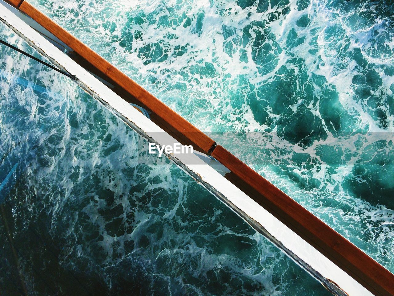 High angle view of sea waves reflecting on boat window