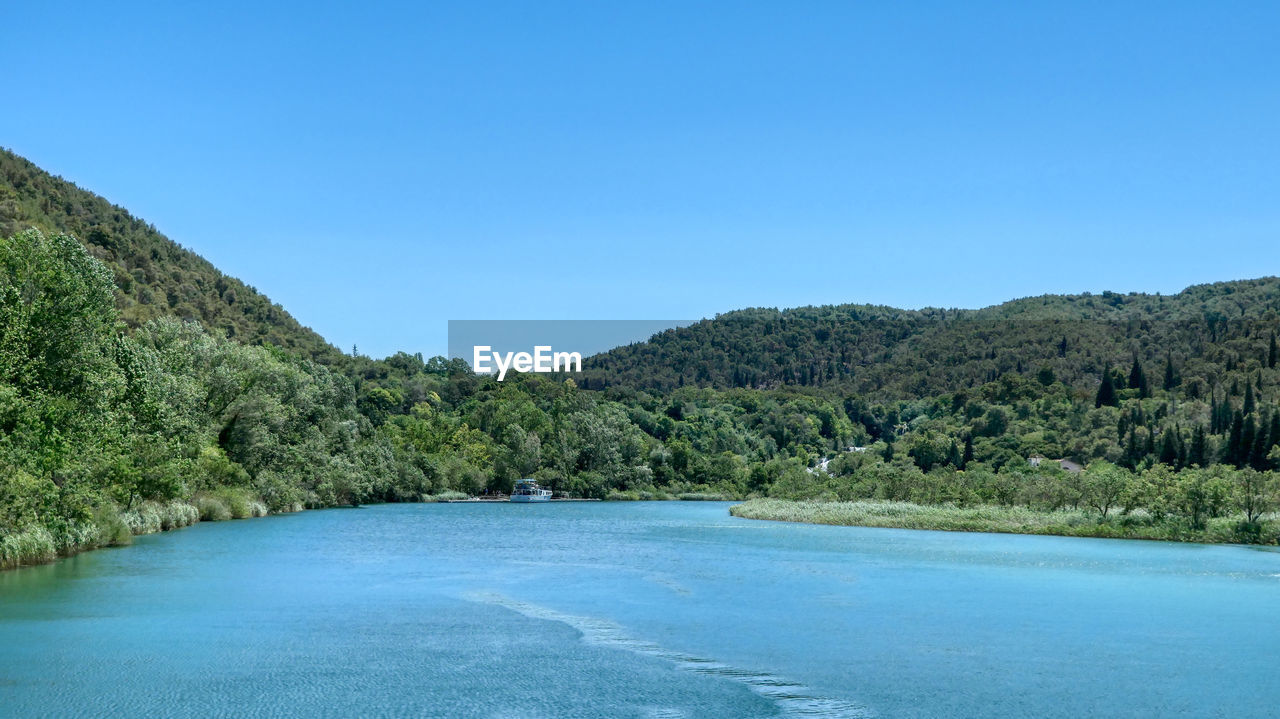 Scenic view of skradinski buk against clear blue sky