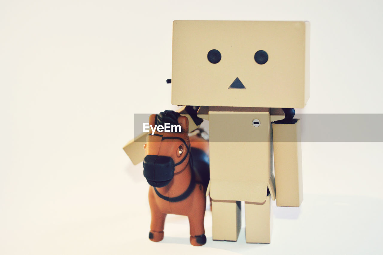 Danboard and toy horse against white background