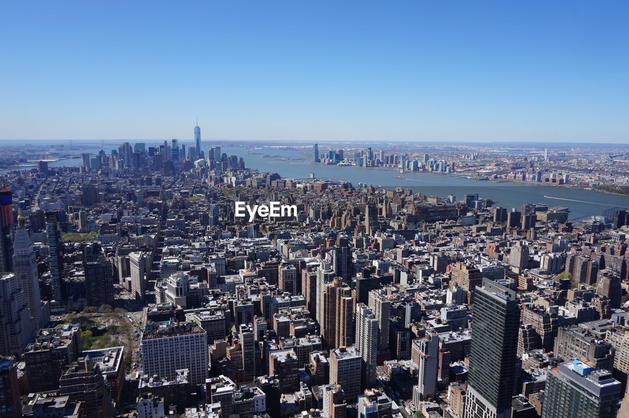 High angle view of cityscape against clear blue sky