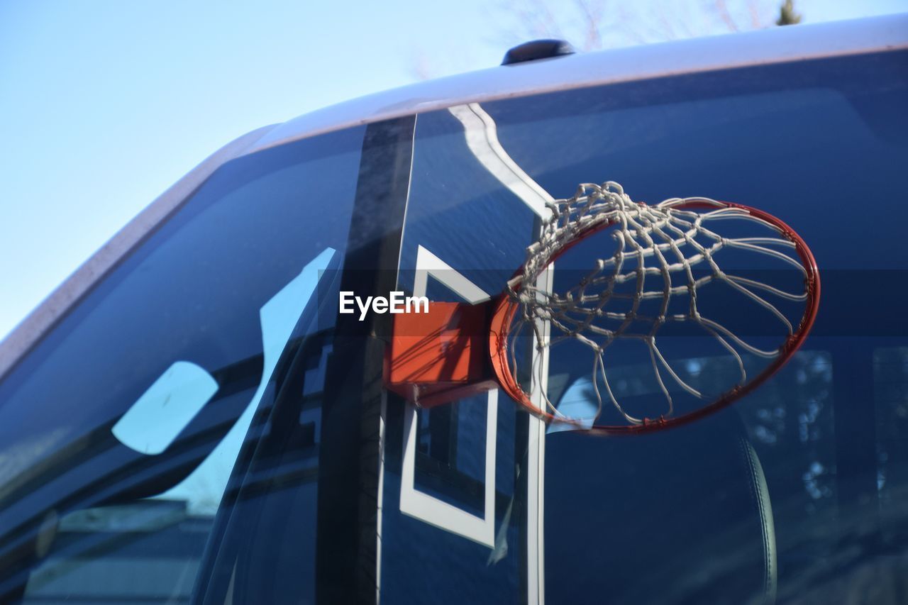 Reflection of basketball hoop on car