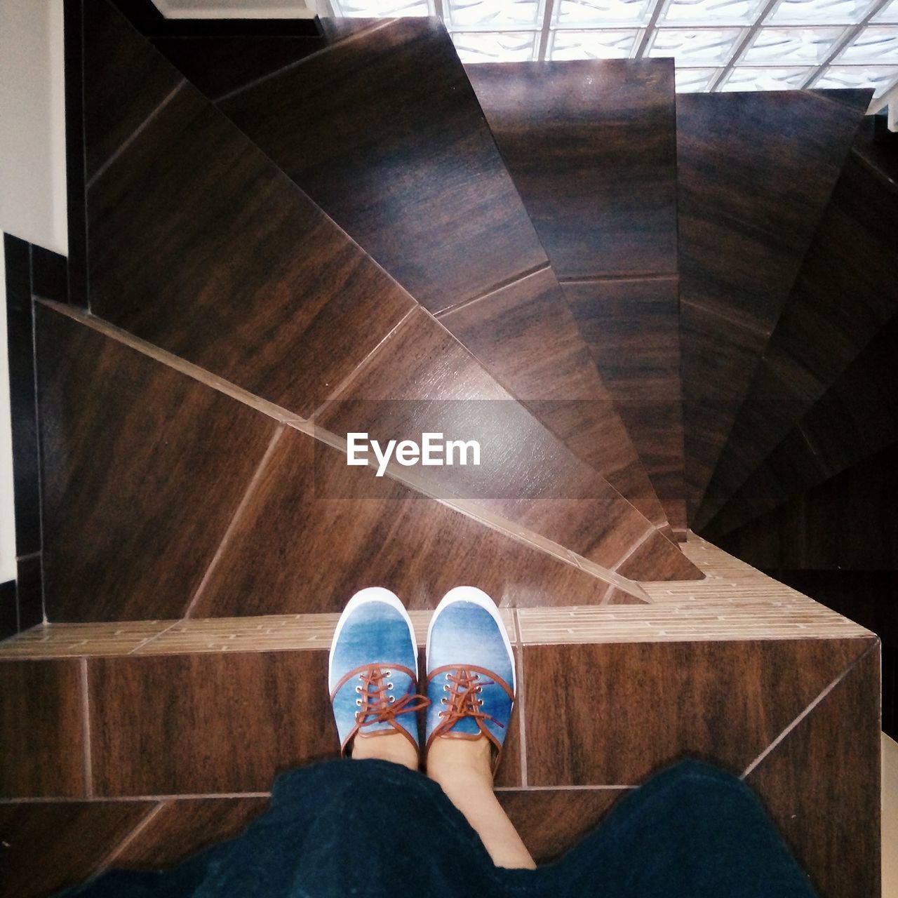 Low section of woman standing on wooden steps