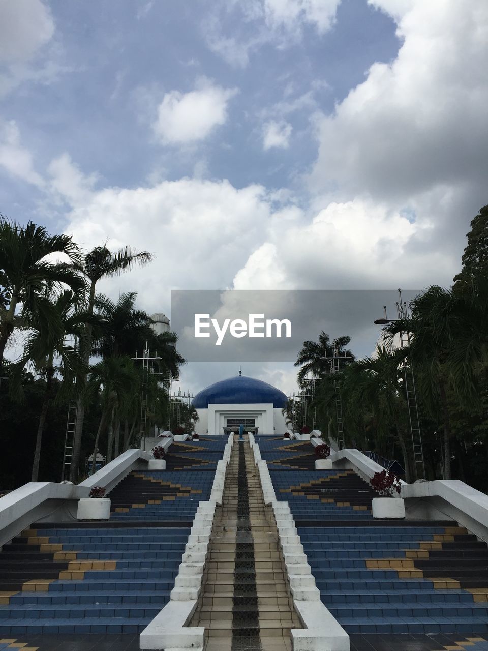 Low angle view of building against cloudy sky