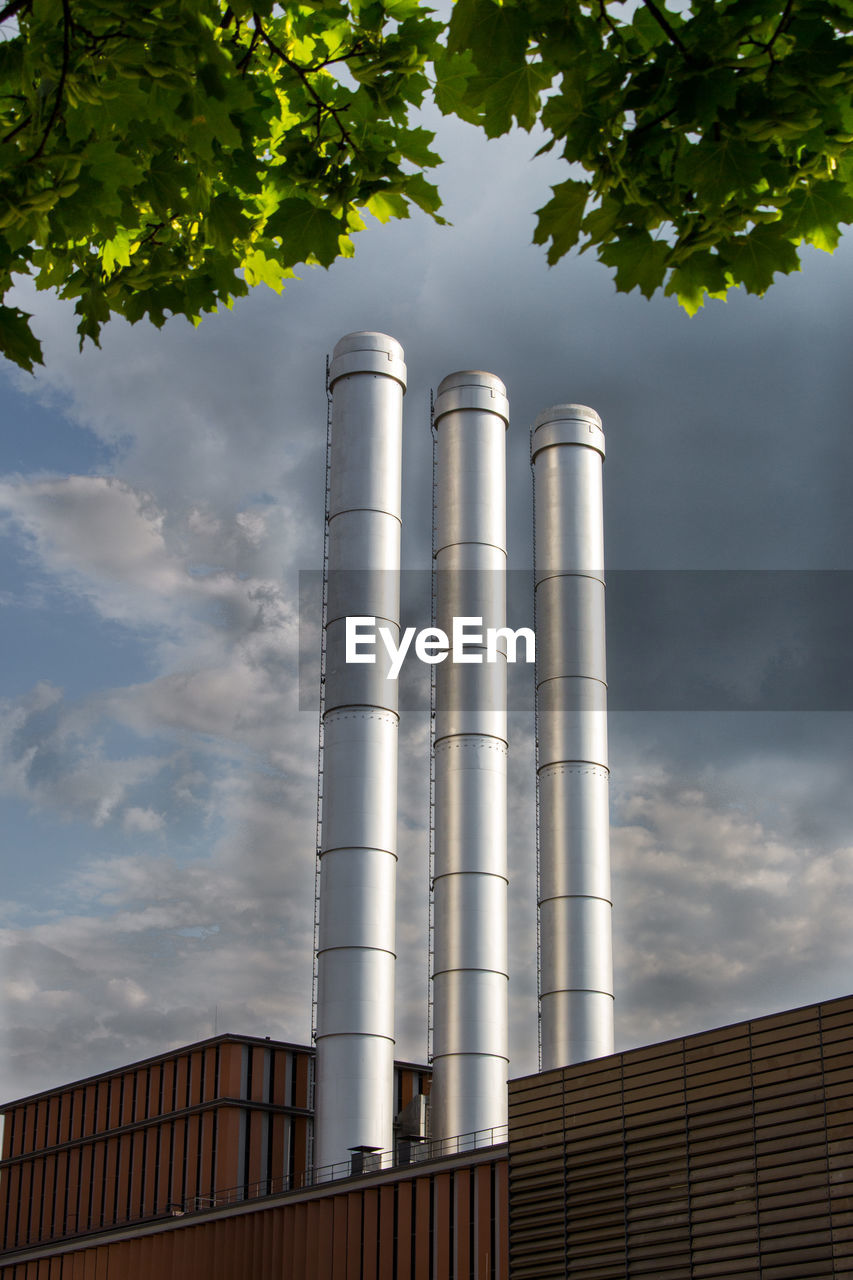 Low angle view of smoke stack against sky