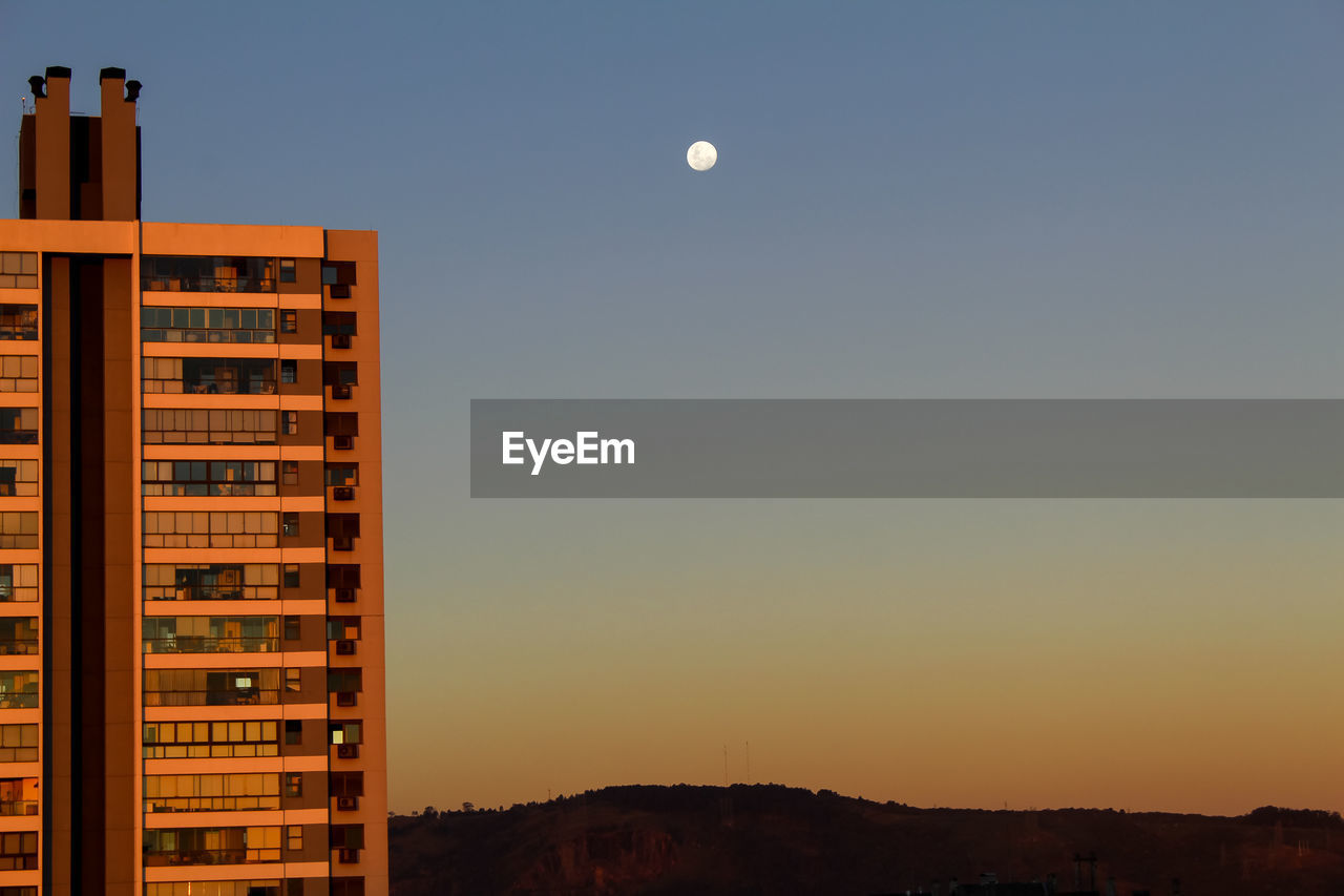 Buildings against sky at sunset