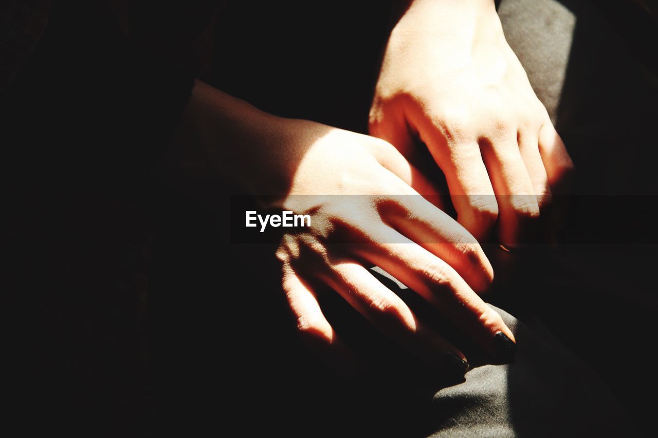 Close-up of sunlight falling on woman hands