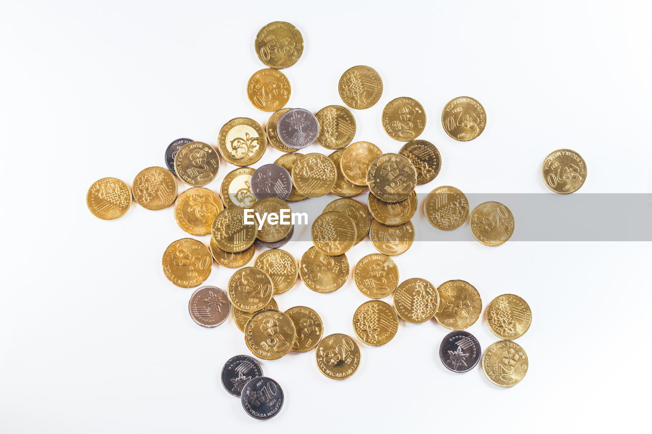 Directly above shot of coins on white background