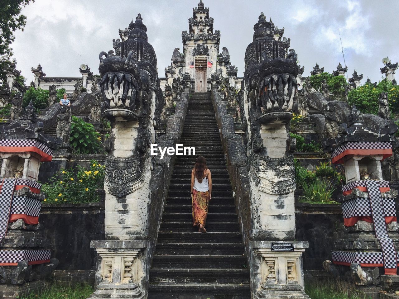 Rear view of a woman walking up stairs