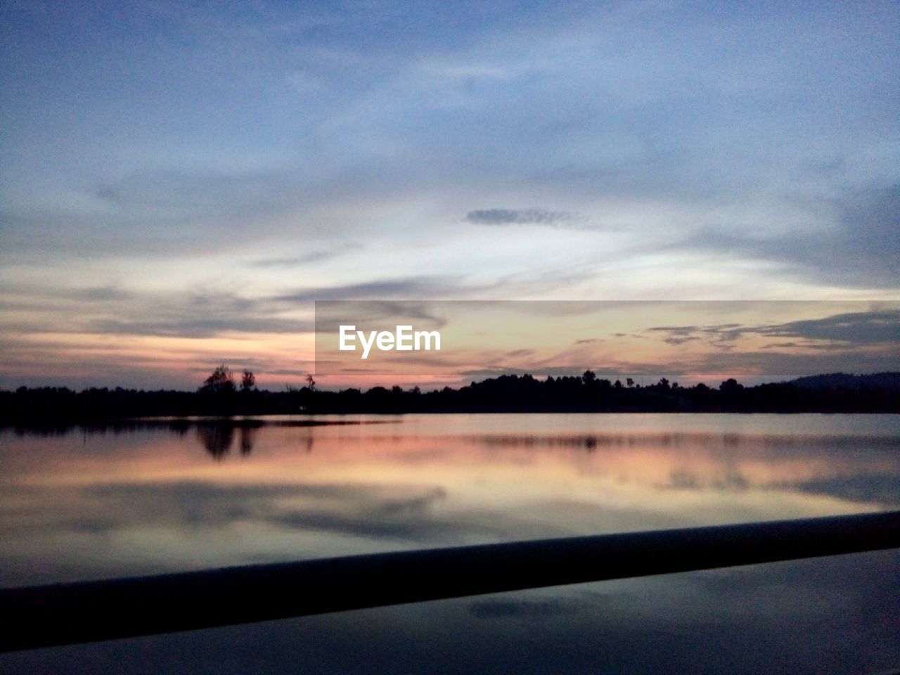 SCENIC VIEW OF LAKE AT SUNSET