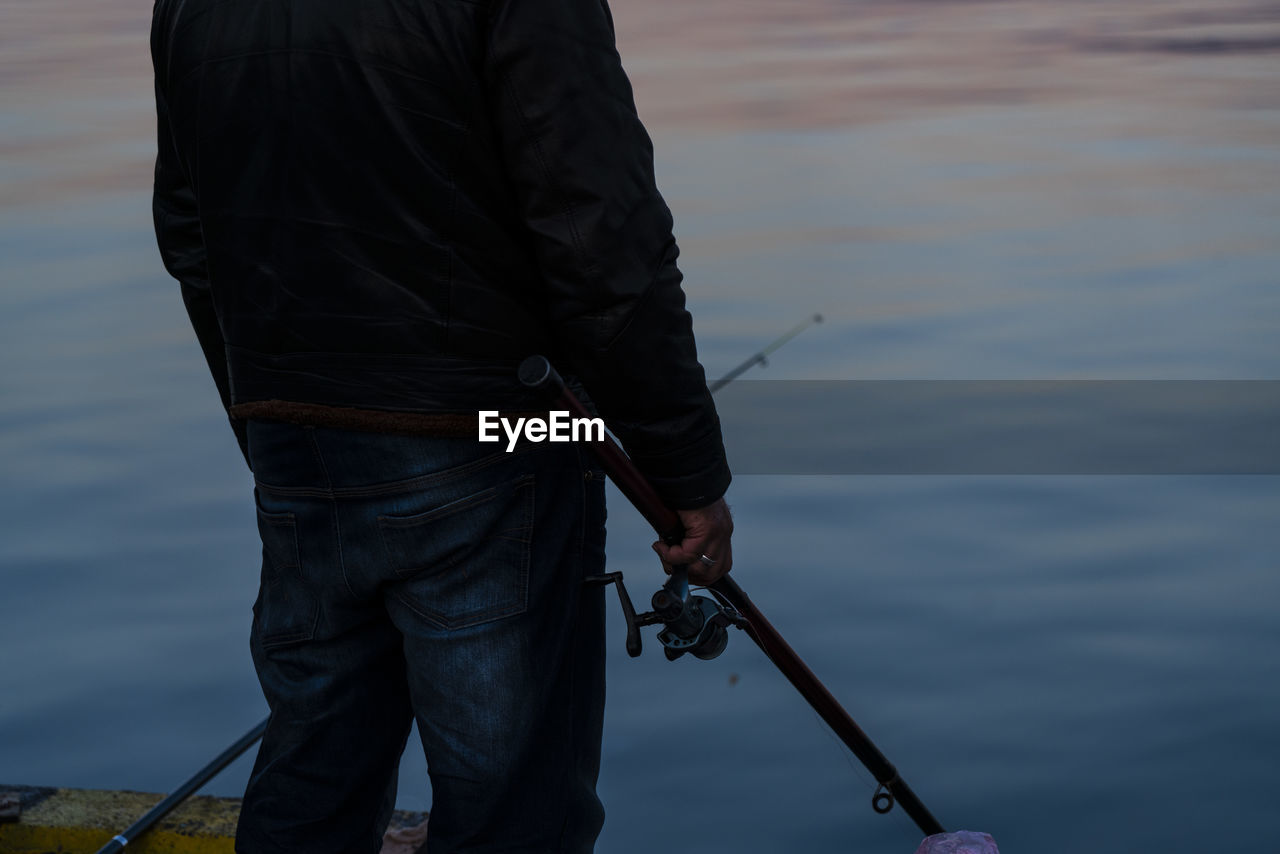 MAN FISHING ON LAKE