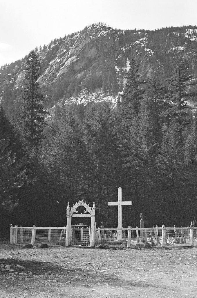 View of cross against rocky mountain