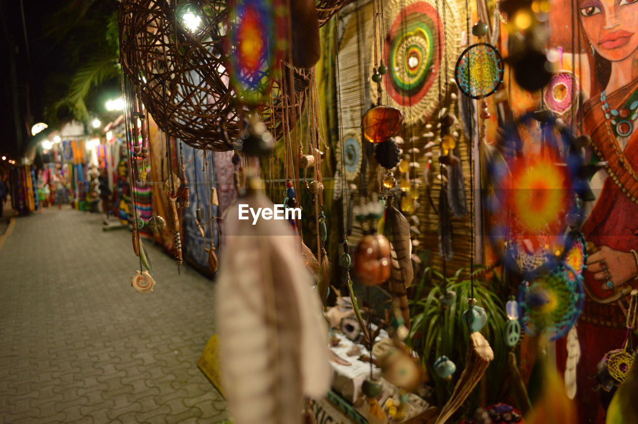 Decorations hanging in illuminated market at night