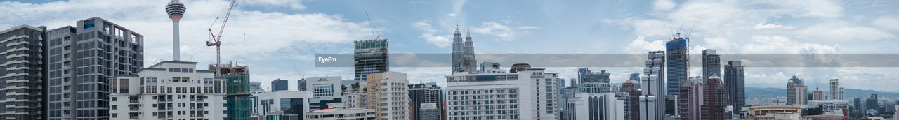 Panoramic view of urban skyline against sky