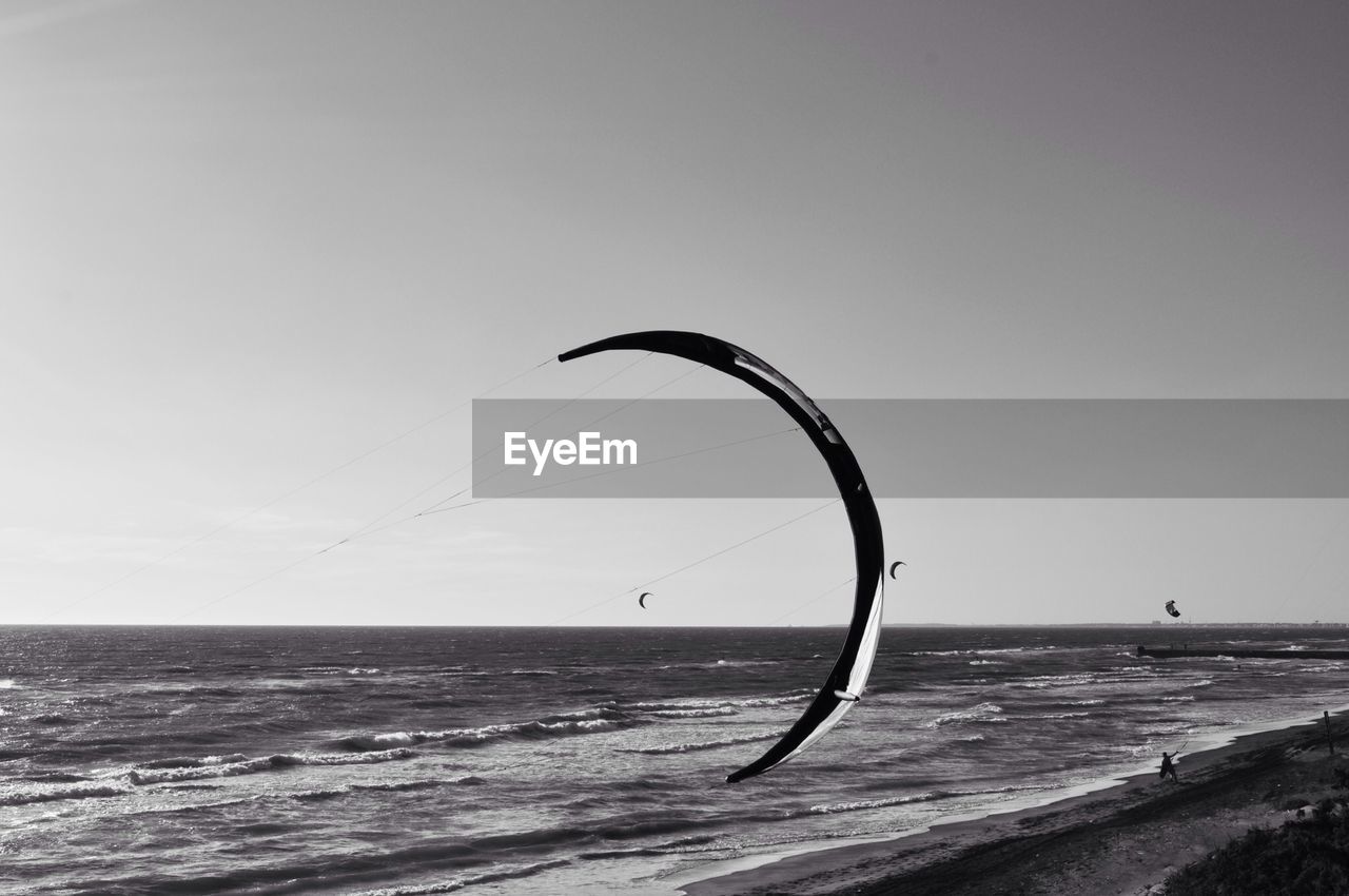 Bended kite against seascape and sky