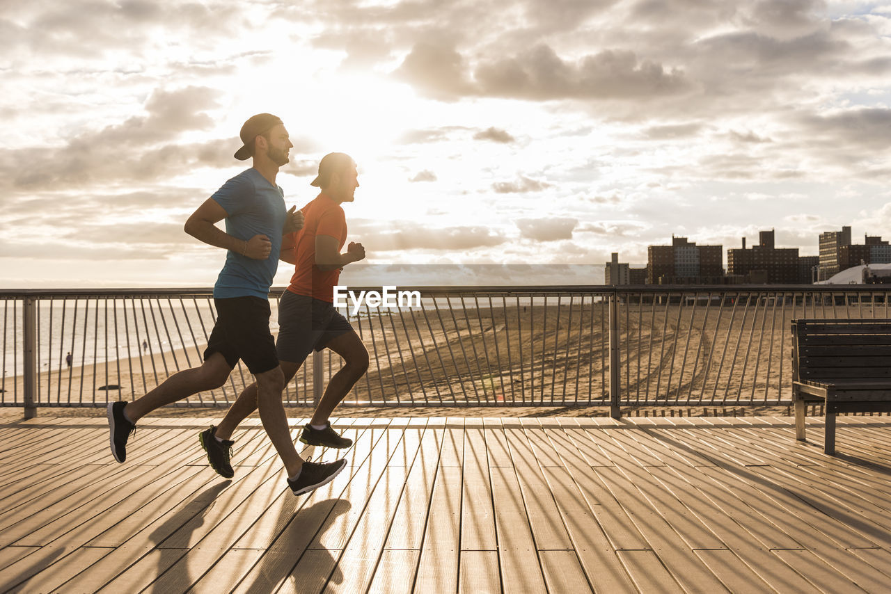 Usa, new york city, two men running on coney island