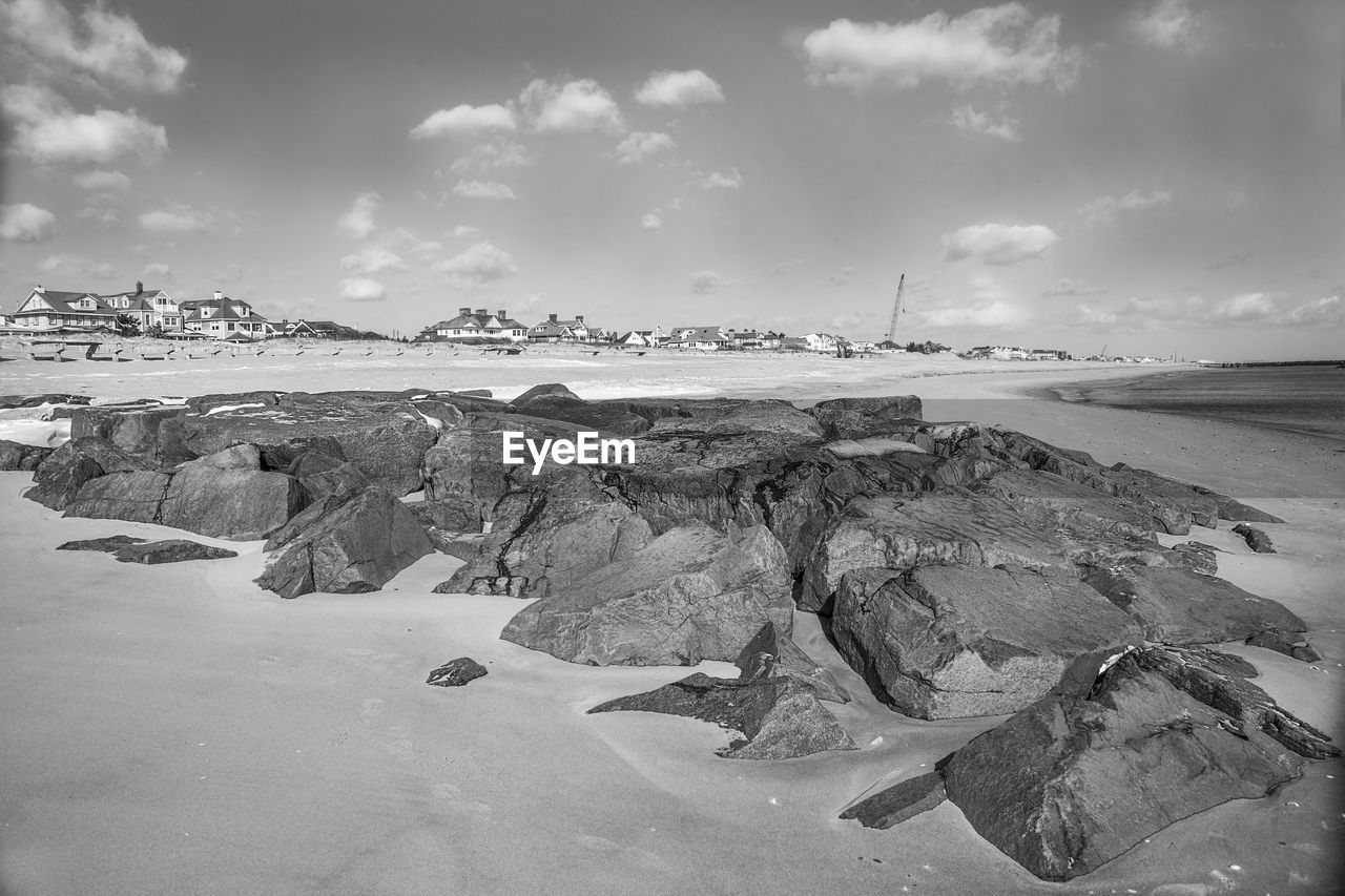 Panoramic view of rocks on beach against sky