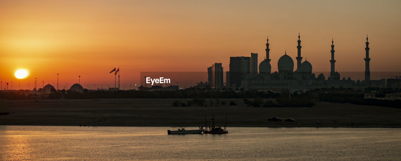 SILHOUETTE OF BUILDINGS IN CITY DURING SUNSET