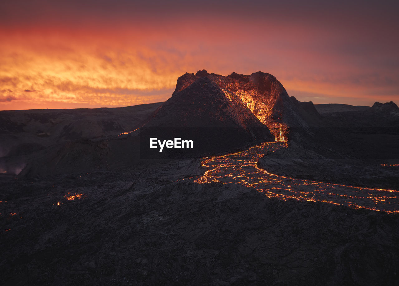 Picturesque view of active volcano with hot lava located against cloudy sunset sky in iceland