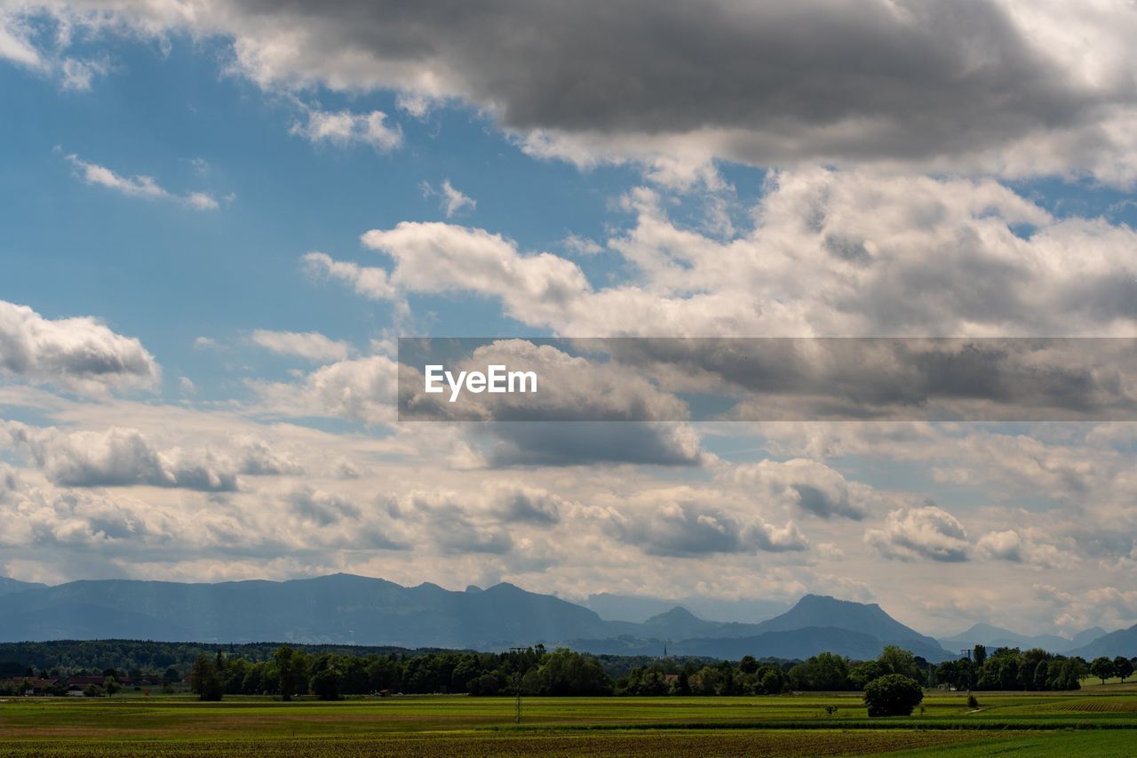 sky, environment, landscape, cloud, horizon, plain, grassland, field, plant, land, nature, scenics - nature, prairie, mountain, beauty in nature, grass, rural scene, agriculture, rural area, no people, meadow, tranquility, tree, outdoors, mountain range, farm, tranquil scene, blue, crop, day, green, food and drink, travel, pasture, food, non-urban scene, cloudscape, travel destinations, steppe, freshness