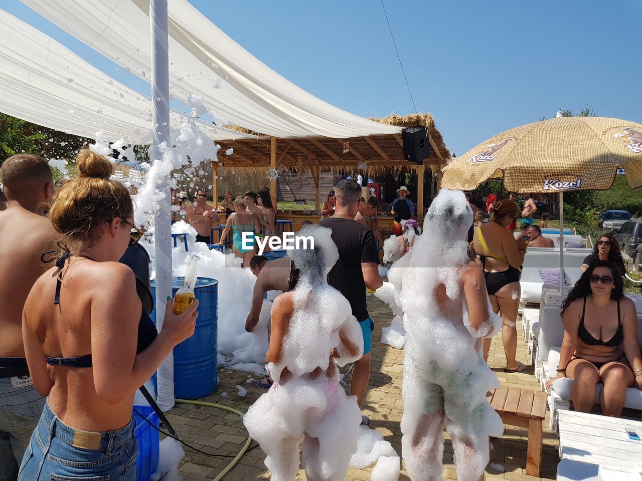 People with soap sud at beach