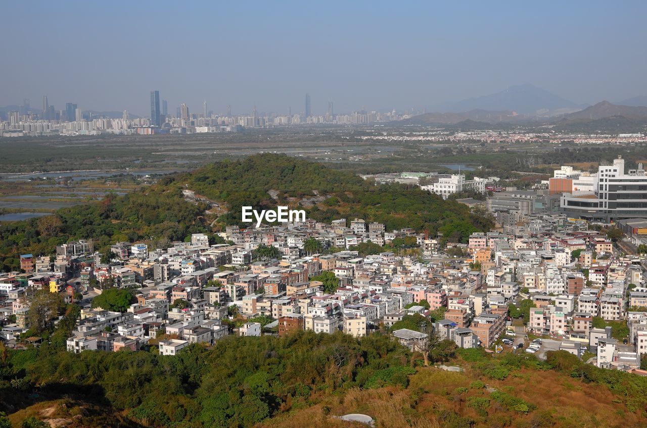 HIGH ANGLE VIEW OF BUILDINGS AGAINST SKY