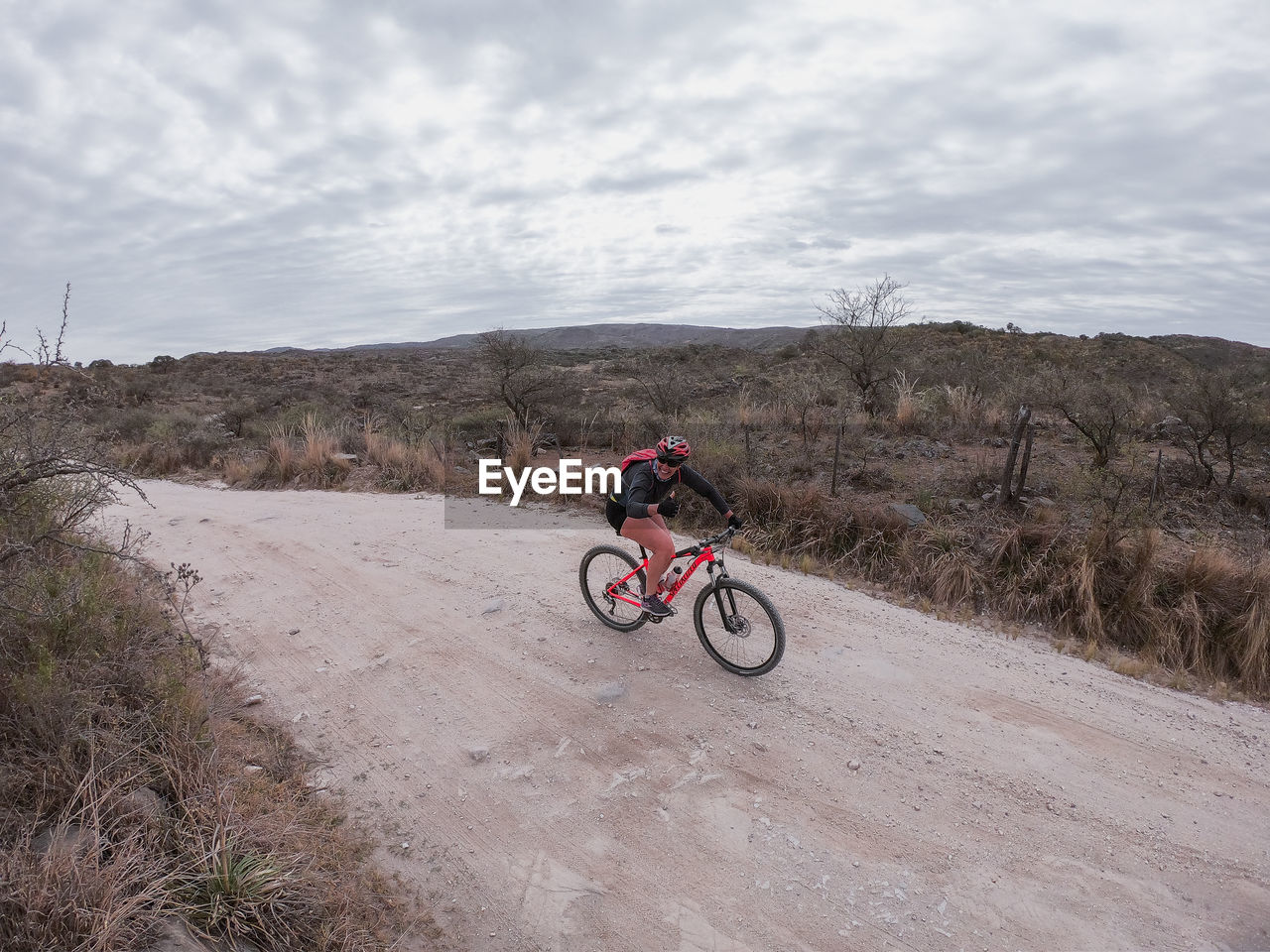 MAN RIDING BICYCLE ON ROAD