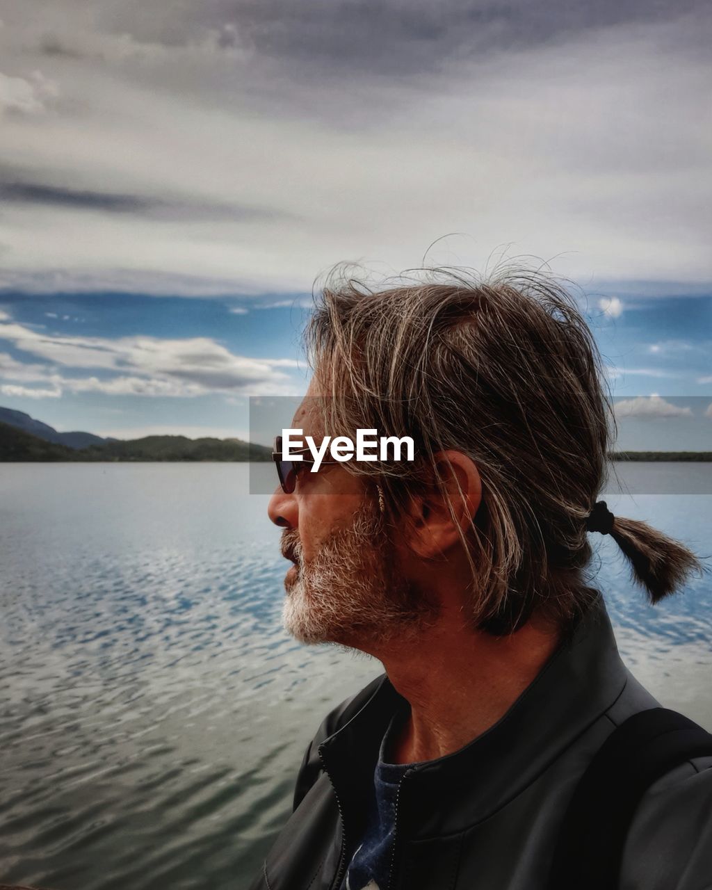 Mature man looking at sea against sky