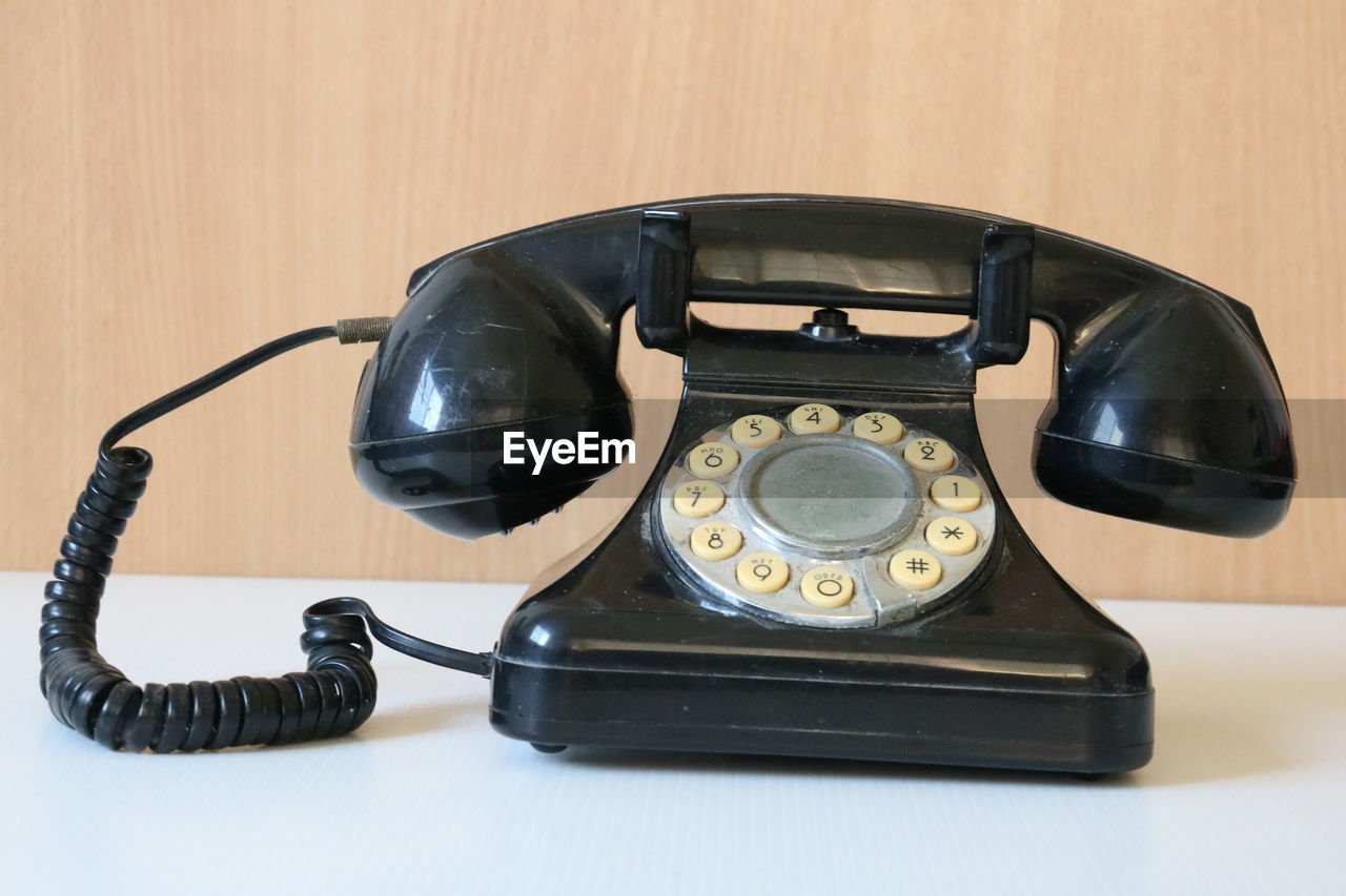 Close-up of telephone on table