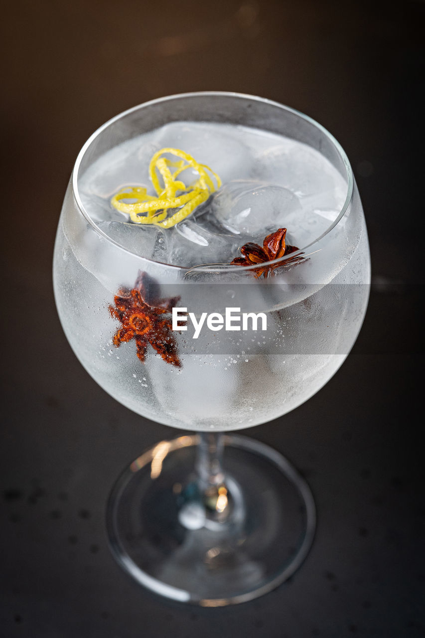 Gin tonic glass on the dark bar counter - mixology concept - three quarter view