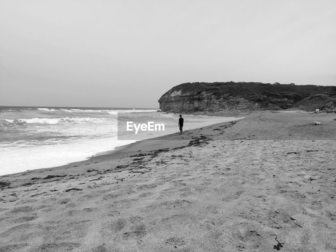 Rear view of people walking on beach