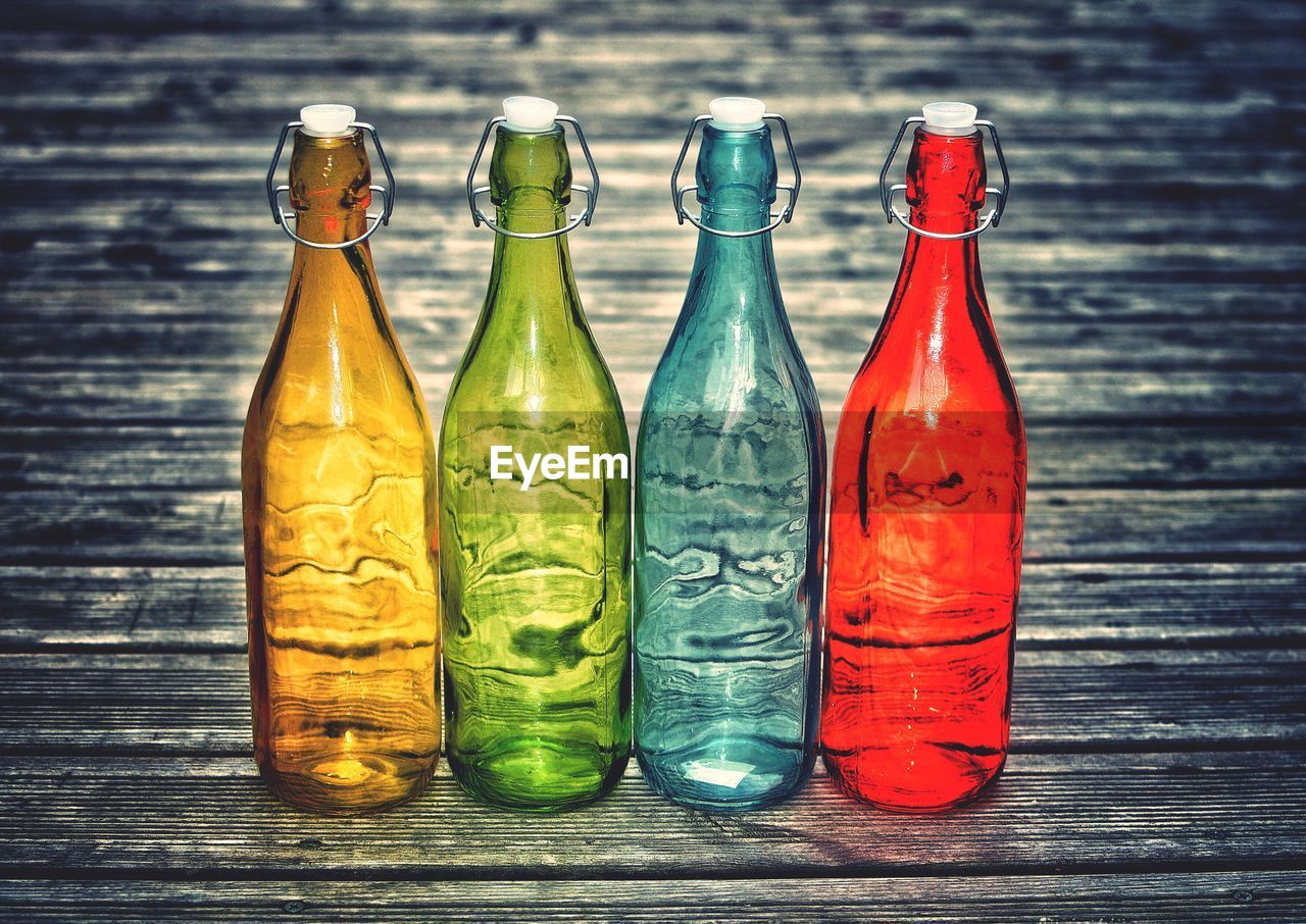 CLOSE-UP OF BOTTLES ON ICE
