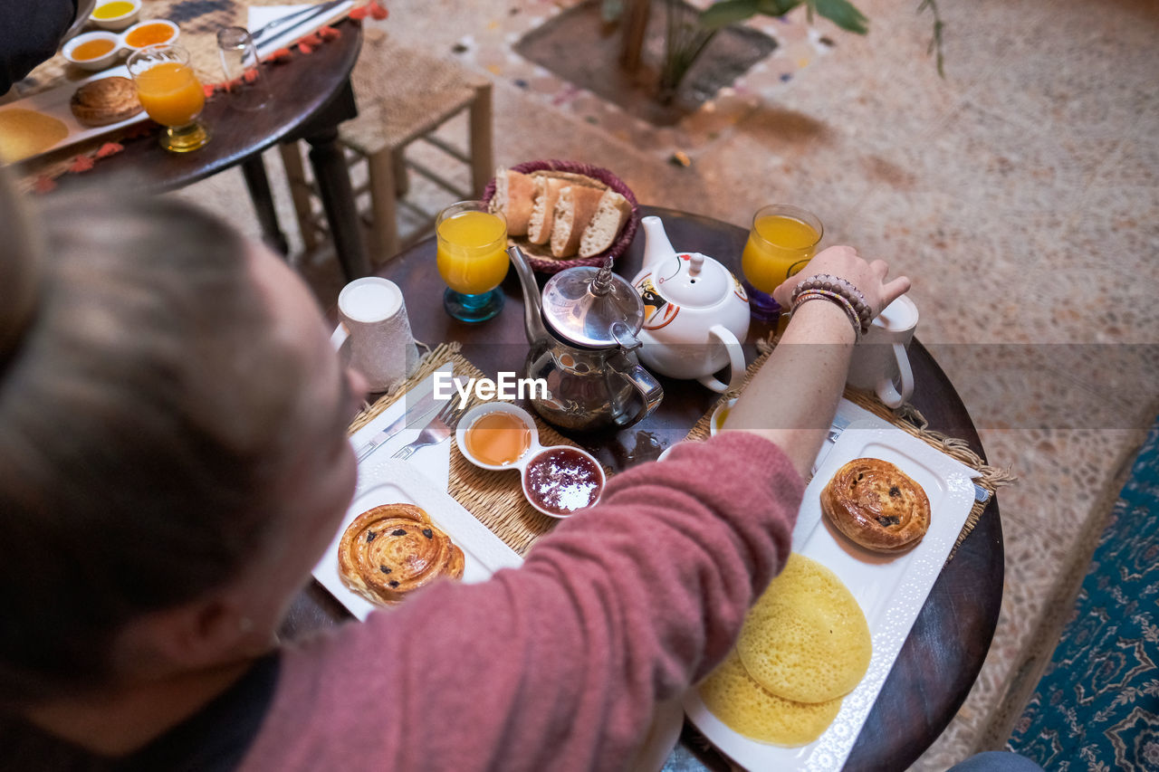 High angle view of man drinking glasses on table