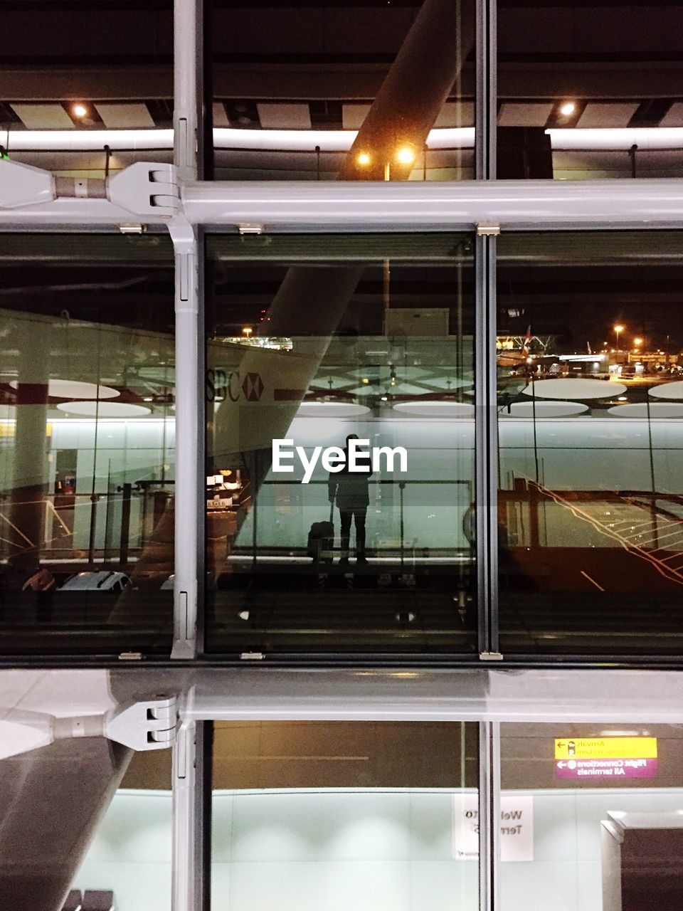 Silhouette man standing in waiting room of london heathrow airport