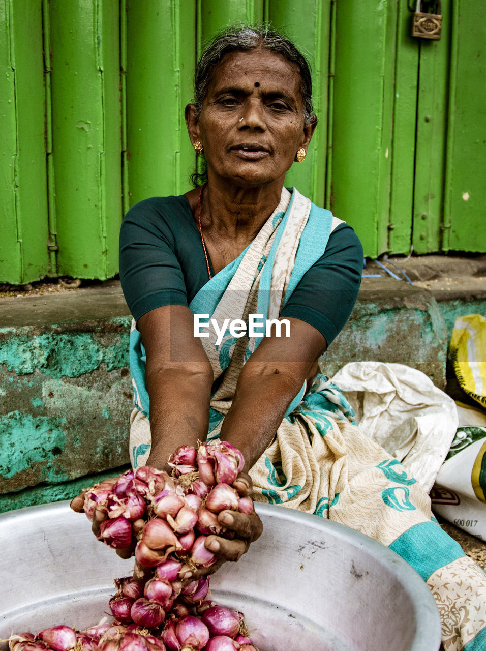 PORTRAIT OF WOMAN HOLDING FOOD OUTDOORS