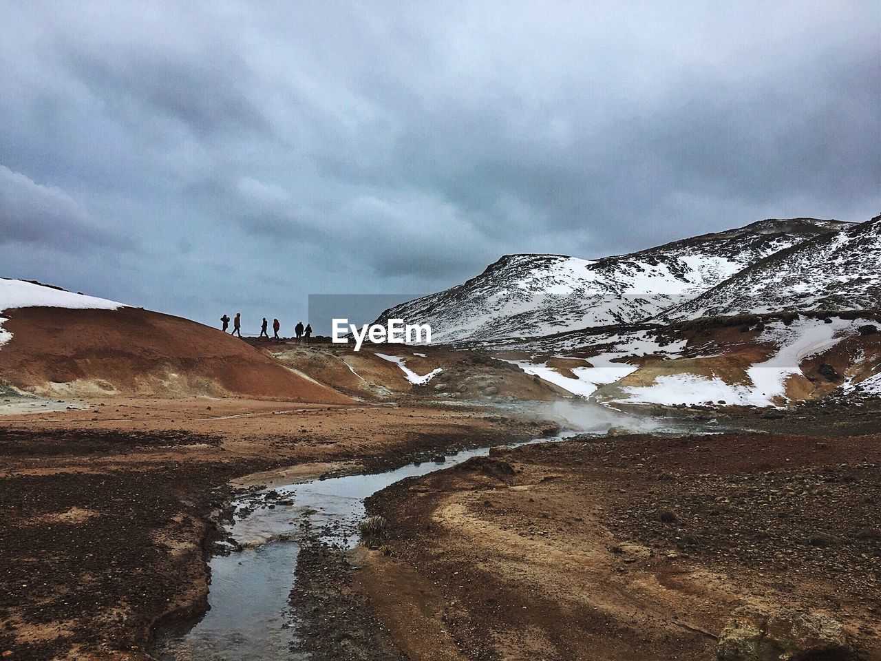 Scenic view of mountain against cloudy sky