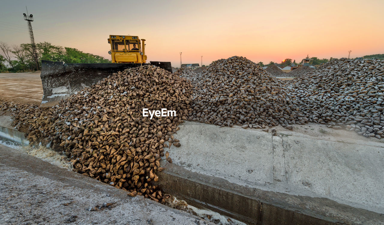 Construction vehicle at site during sunset